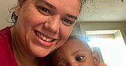 Cameron is registered to the contest to win money with this photo: woman, child, toddler, smile, curly_hair, indoor, natural_light, portrait, family, happy, casual_clothing, closeup, people, skin, face, head, baby, affection, mother_and_child, candid