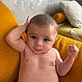 baby, infant, diaper, chair, mustard_yellow, curious, pose, skin, indoors, cushion, expression, cute, child, young, person, relaxing, casual, furniture, portrait, face