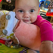 Luna joined the competition — help win amazing prizes! baby, child, smiling, face, hand, toy, blanket, colorful, indoor, closeup, cute, infant, soft, plush, playmat, person, bright, happy, clothing, expression