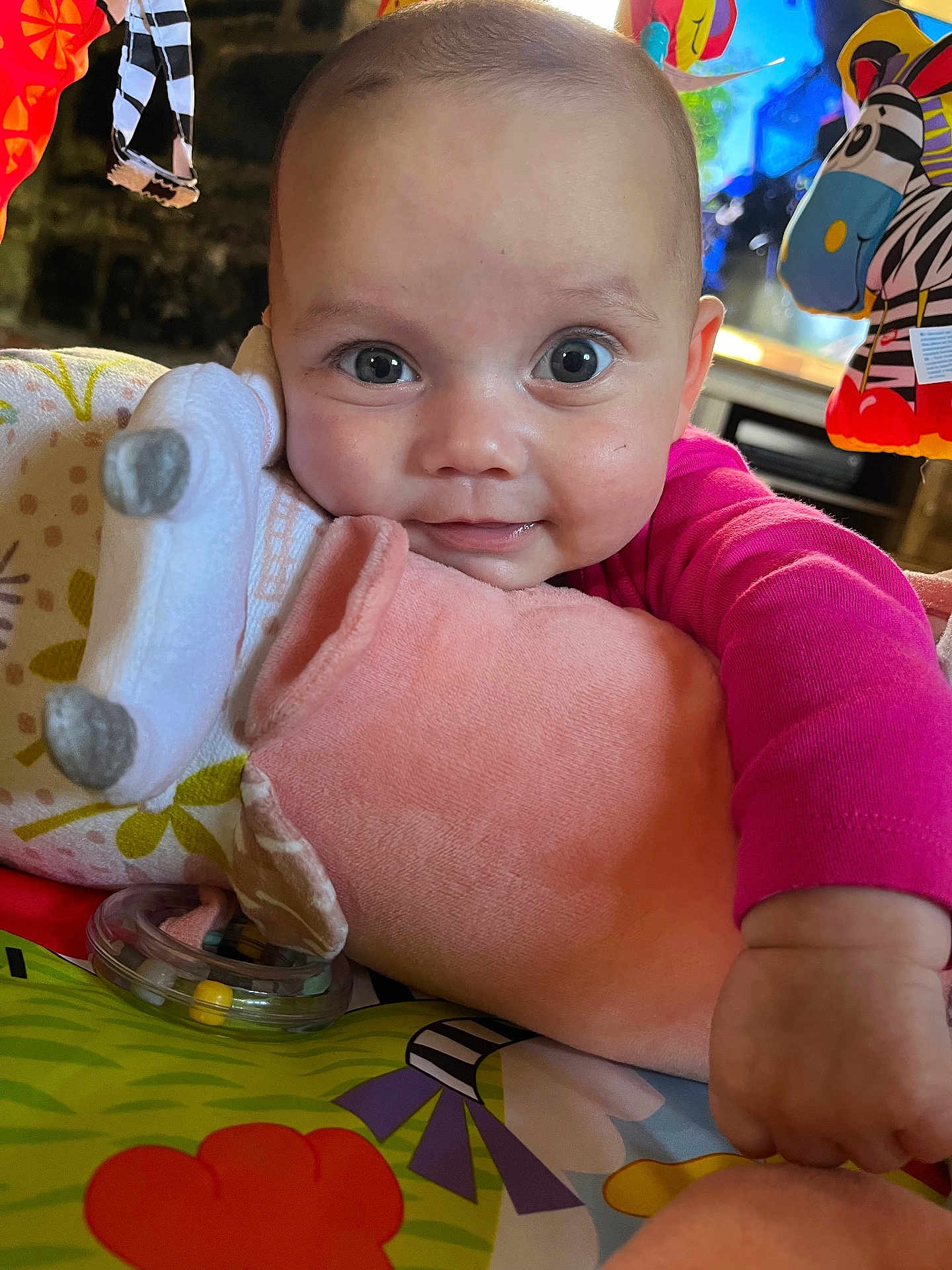 Luna joined the competition — help win amazing prizes! baby, child, smiling, face, hand, toy, blanket, colorful, indoor, closeup, cute, infant, soft, plush, playmat, person, bright, happy, clothing, expression