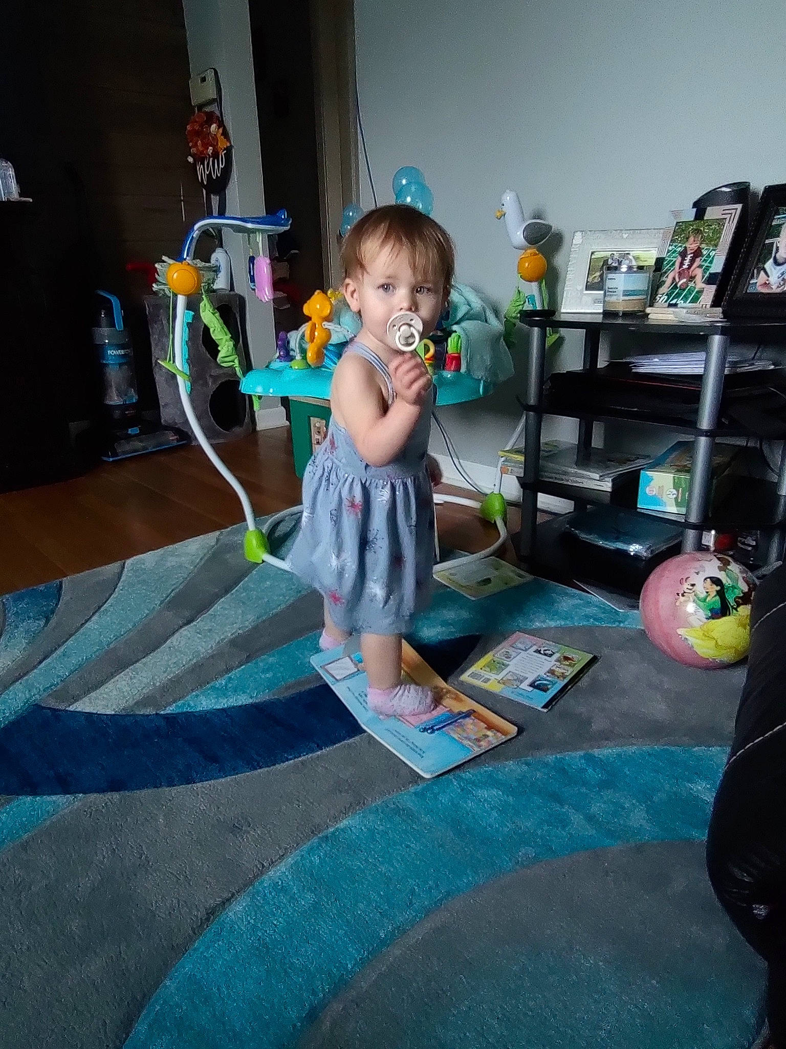 Alexandra is registered to the contest to win money with this photo: baby, baby_toys, bookcase, carpet, child, floor, flooring, fun, hardwood, house, leisure, living_room, person, play, room, shelf, sitting, toddler, toy, visual_arts