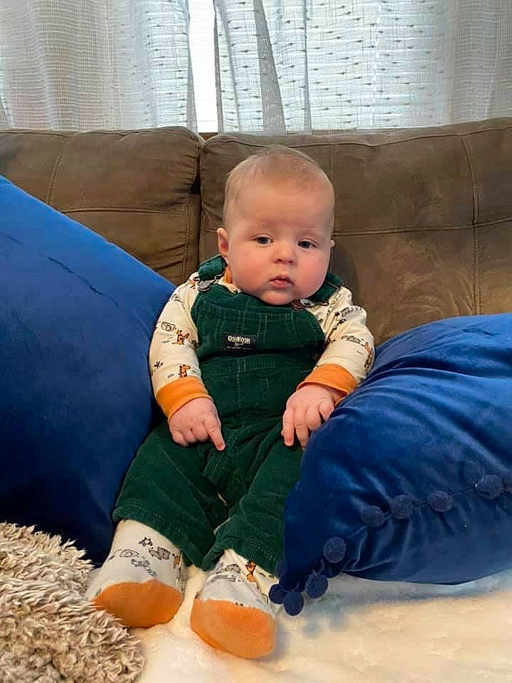 Clay is registered to the contest to win money with this photo: baby, baby_toddler_clothing, child, comfort, couch, flooring, foot, fun, human_leg, lap, leisure, person, play, recreation, room, sitting, sleeve, sock, toddler, vertebrate