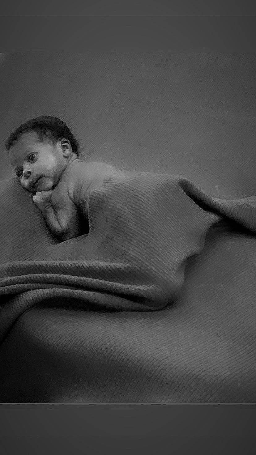 Ivan is registered to the contest to win money with this photo: arm, art, baby, barechested, chest, child, comfort, elbow, flash_photography, fur, gesture, head, human_body, human_leg, linens, monochrome, monochrome_photography, person, sitting, toddler