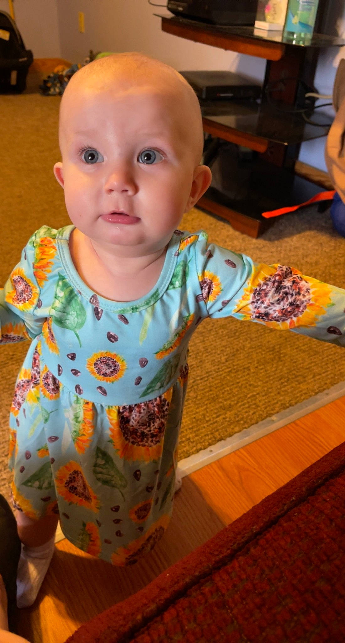 Camryn is registered to the contest to win money with this photo: baby, baby_toddler_clothing, cheek, child, chin, computer_keyboard, floor, flooring, fun, happy, hardwood, head, iris, pattern, person, sitting, skin, sleeve, t_shirt, toddler