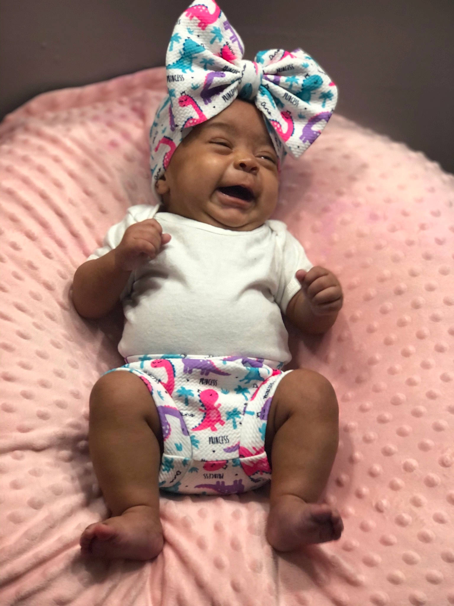 Maleah is registered to the contest to win money with this photo: baby, baby_toddler_clothing, cap, cheek, child, clothing, comfort, face, happy, head, headgear, headwear, outerwear, person, photograph, pink, purple, skin, sleeve, smile
