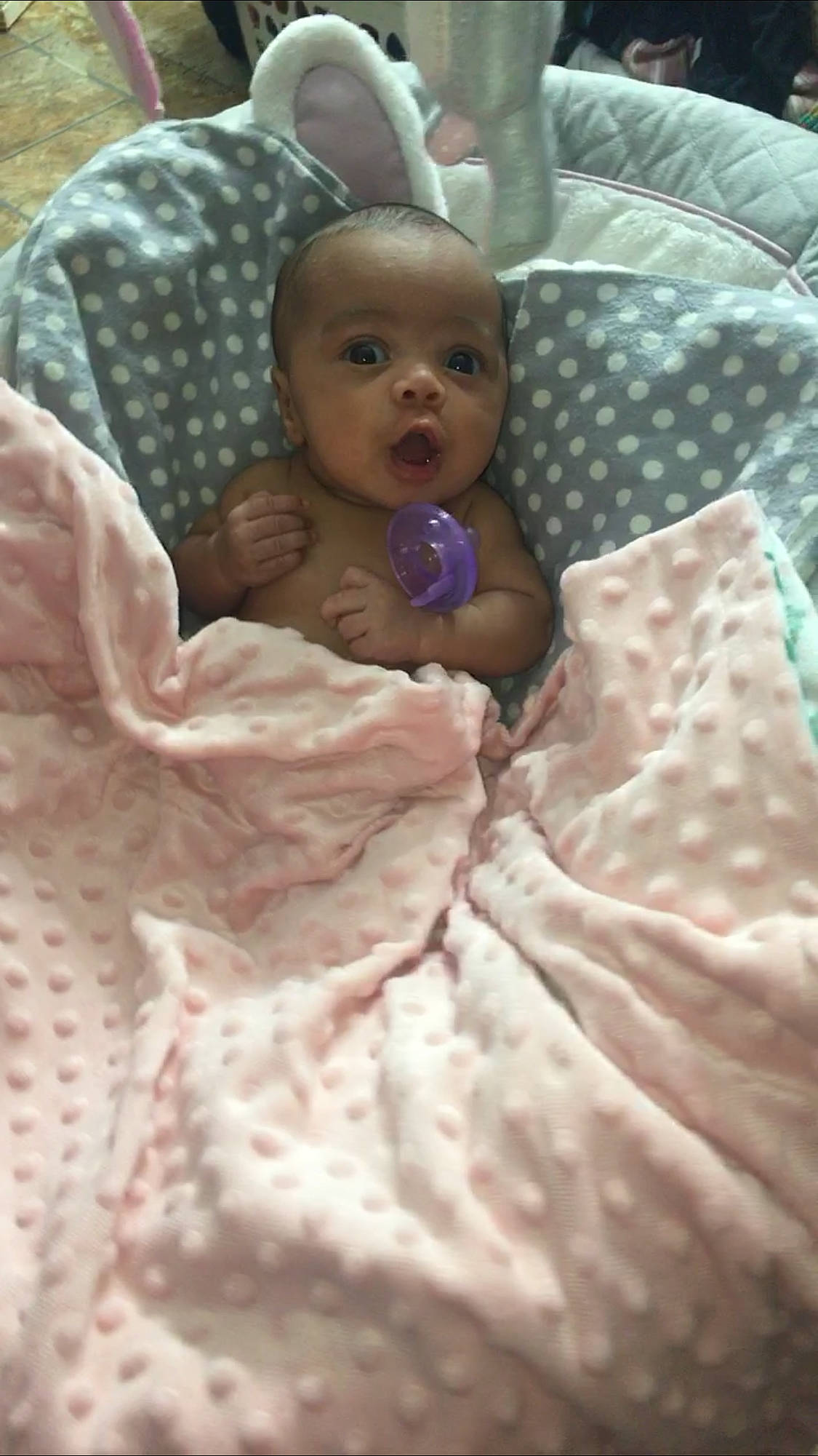 Maleah is registered to the contest to win money with this photo: baby, baby_safety, baby_toddler_clothing, bed, bed_sheet, bedding, cheek, child, comfort, eye, linens, mouth, pattern, peach, person, pink, room, skin, sleeve, textile