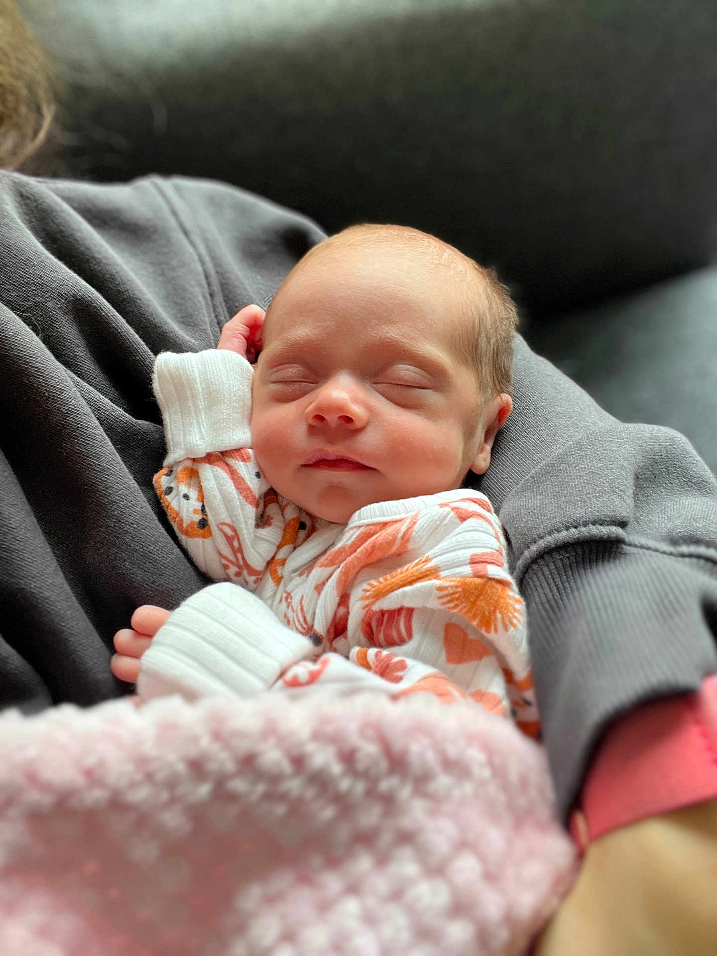 Oakley joined the competition — help win amazing prizes! baby, newborn, sleeping, blanket, onesie, patterned_clothing, person, arm, sleeve, cozy, soft_texture, indoor, closeup, face, peaceful, infant, rest, cuddle, comfort, warmth