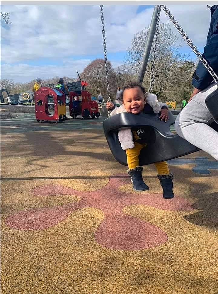 Nevaeh Horstead is registered to the contest to win money with this photo: asphalt, city, cloud, event, flooring, fun, happy, jacket, joy, leisure, person, playground, public_space, recreation, road_surface, sky, smile, swing, tire, toddler