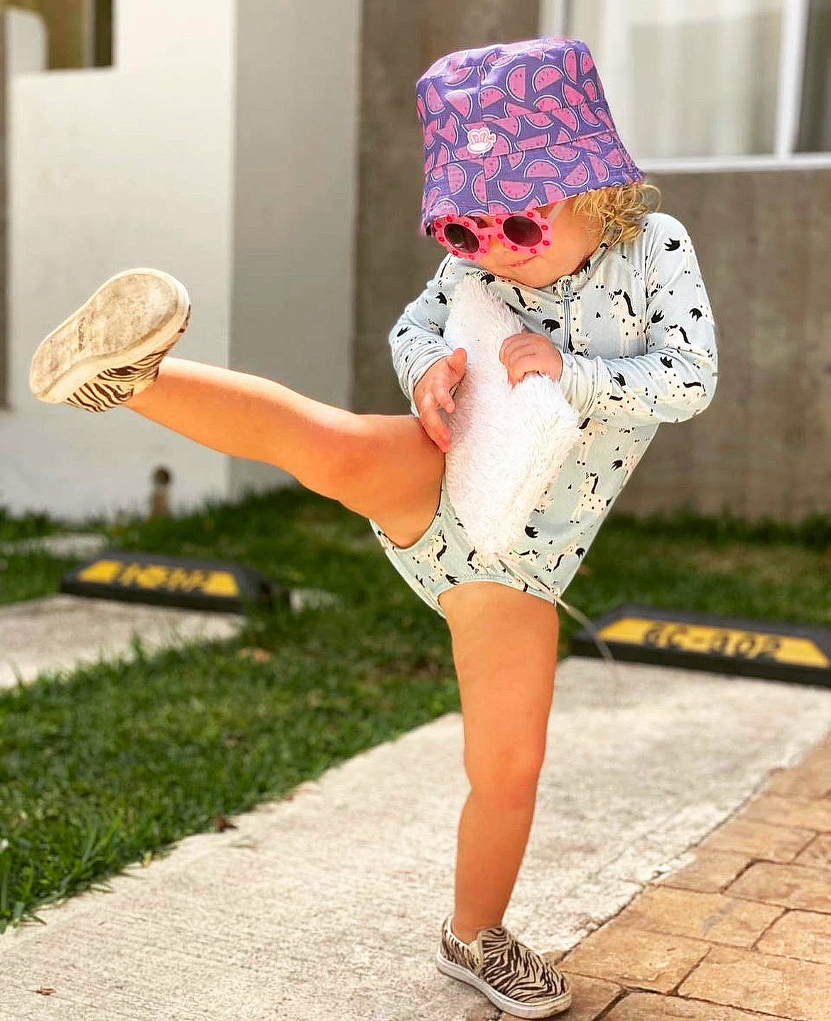 Samantha joined the competition — help win amazing prizes! baby_toddler_clothing, cap, entertainment, eyewear, fashion_design, grass, happy, hat, human_leg, knee, leg, pattern, person, pink, shoe, sleeve, sneakers, sportswear, thigh, toddler