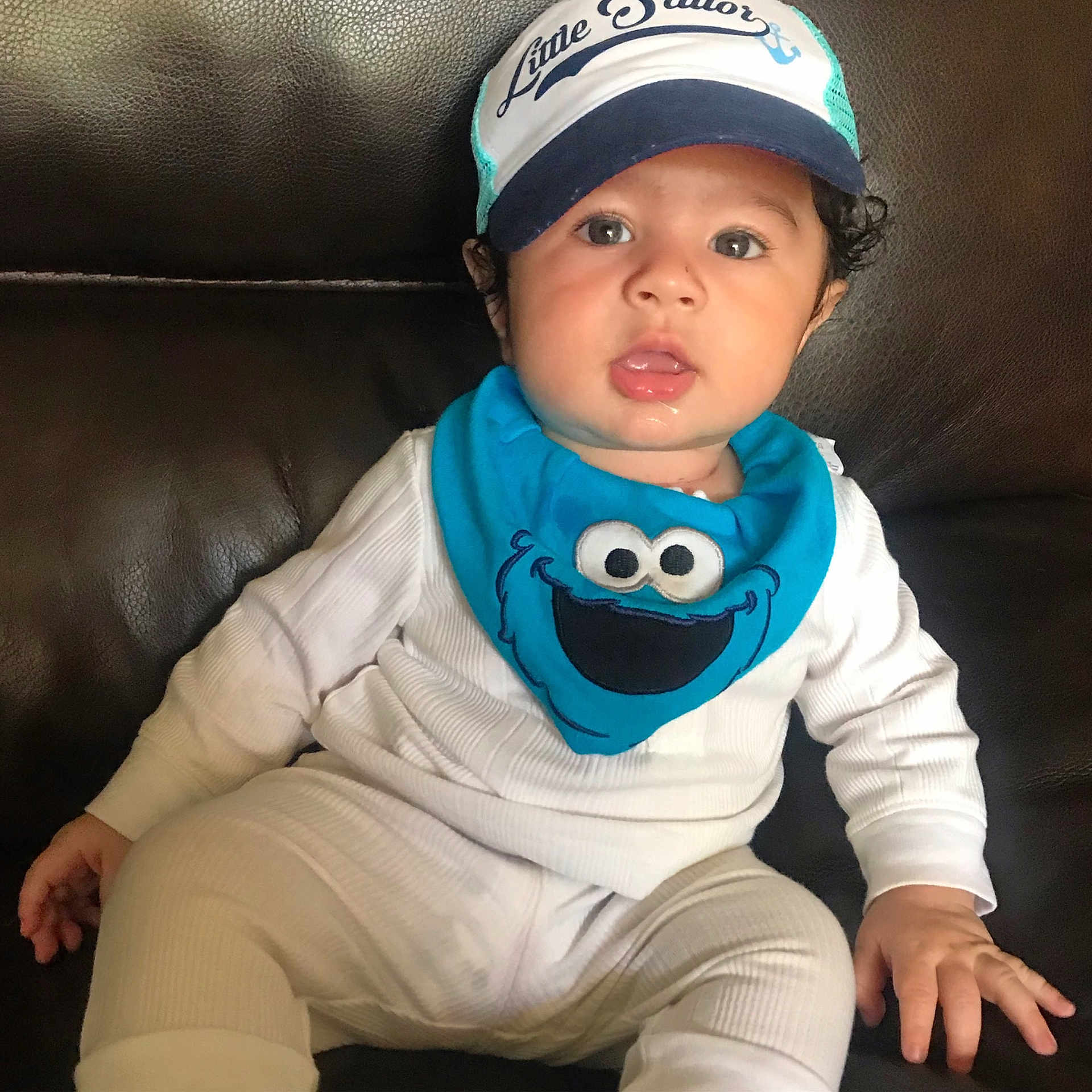 Arthur is registered to the contest to win money with this photo: baby, cap, child, cool, headgear, headwear, person, sleeve, t_shirt, toddler, turquoise