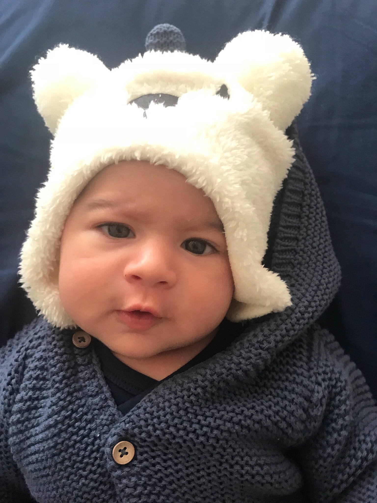 Arthur is registered to the contest to win money with this photo: baby, beanie, bear, bonnet, cap, cheek, child, ear, fur, fur_clothing, hat, head, headgear, headwear, knit_cap, organ, outerwear, person, skin, teddy_bear