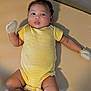 Jedi joined the competition — help win amazing prizes! baby, infant, child, striped_clothing, yellow_clothing, onesie, mittens, lying_down, beige_background, shadow, curly_hair, cheeks, skin, cute, portrait, indoors, person, soft_lighting, expression, small_arms