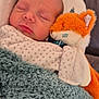 Esteban participe au concours pour gagner de l'argent avec cette photo : newborn, baby, sleeping, blanket, plush_toy, fox, cozy, infant, soft, cute, child, resting, comfort, warm, indoors, portrait, face, clothing, cute_toy, peaceful
