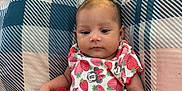 Jaylani is registered to the contest to win money with this photo: baby, bedroom, child, cute, fabric, home, indoor, infant, minnie_mouse, patterned_clothing, person, pillow, plaid_pattern, red_skirt, resting, sitting, smiling, soft_lighting, strawberry_print, toddler