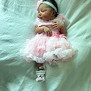 Jaylani is registered to the contest to win money with this photo: baby, closeup, cute, fabric, feet, hands, headband, infant, lying_down, newborn, peaceful, pink_dress, portrait, ribbons, sleeping, sock, soft_light, texture, toddler, white_blanket