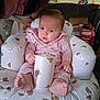 baby, bear_pattern, cardboard_boxes, casual, cheez_it, child, cushioned_chair, expression, face, feet, hand, indoor, infant, living_room, person, pink_clothing, polka_dots, snack_box, sofa, tattooed_adult