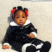 Selaphiel joined the competition — help win amazing prizes! toddler, child, sitting, couch, black_jacket, white_fur, polka_dot_leggings, red_bows, beads, hair, face, expression, indoor, furniture, cute, portrait, person, clothing, footwear, cozy