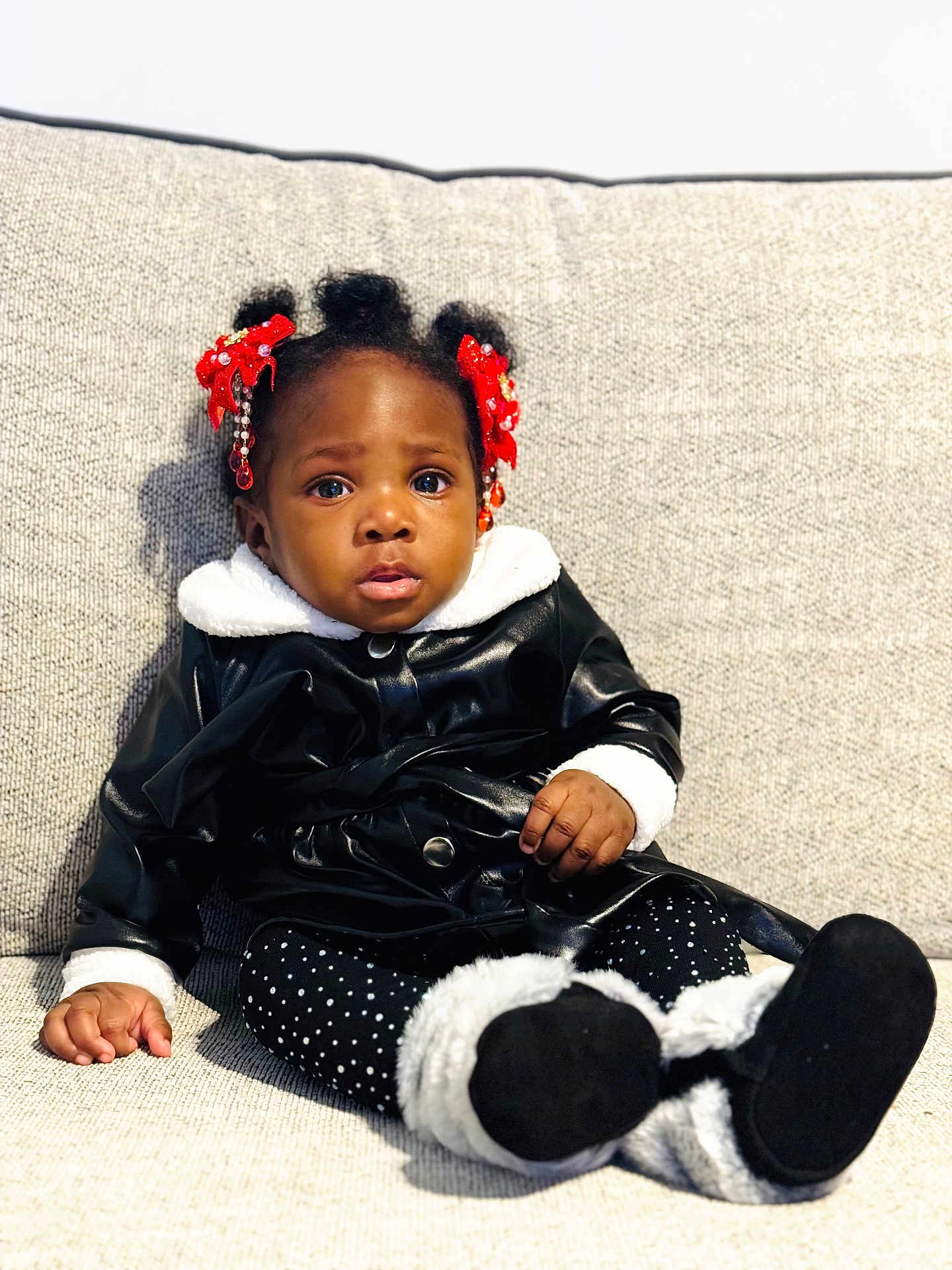 Selaphiel joined the competition — help win amazing prizes! toddler, child, sitting, couch, black_jacket, white_fur, polka_dot_leggings, red_bows, beads, hair, face, expression, indoor, furniture, cute, portrait, person, clothing, footwear, cozy