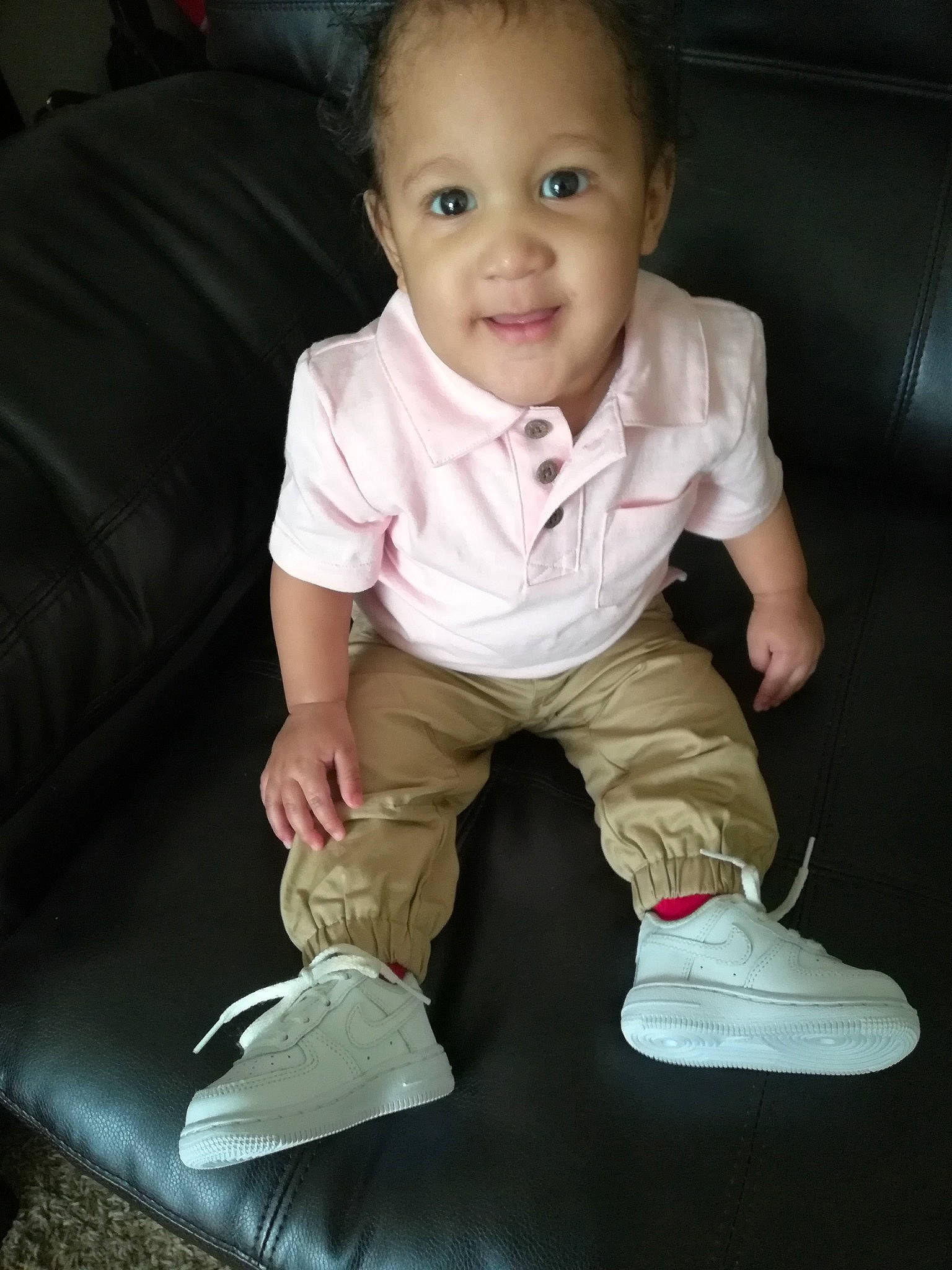 Harlem is registered to the contest to win money with this photo: baby, baby_toddler_clothing, cheek, child, chin, footwear, fun, head, leg, nose, person, play, shoe, sitting, skin, sleeve, smile, standing, t_shirt, toddler