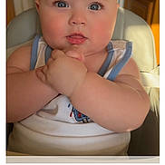 Benjamin joined the competition — help win amazing prizes! baby, child, blue_eyes, high_chair, hands, clasped_hands, face, skin, arm, kitchen, light, warm_light, indoor, person, cute, infant, tank_top, expression, closeup, portrait