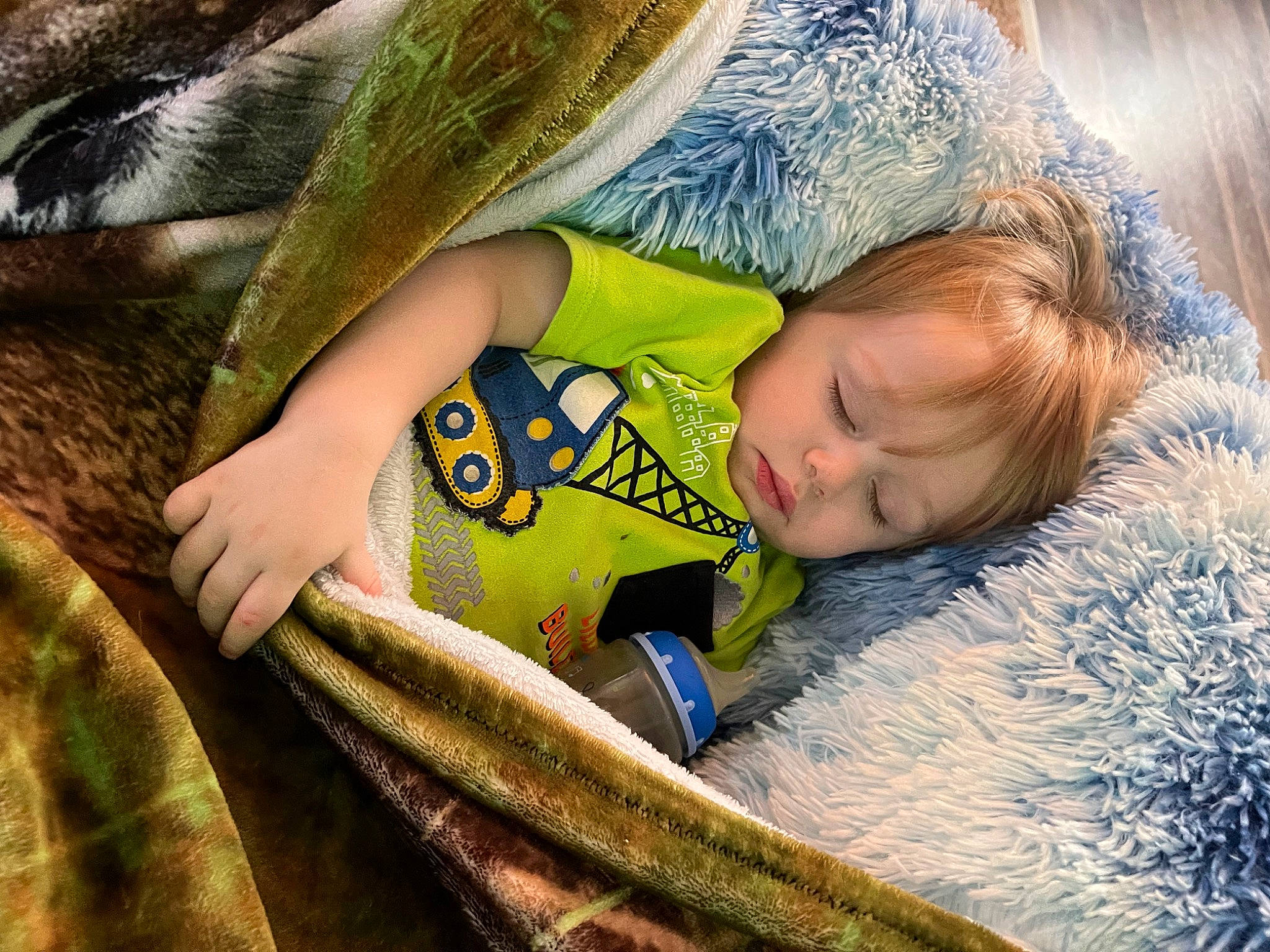 Aiden is registered to the contest to win money with this photo: child, comfort, eye, facial_expression, fun, fur, grass, grass_family, hand, happy, leisure, people_in_nature, person, plant, sitting, skin, sunlight, textile, toddler, tree