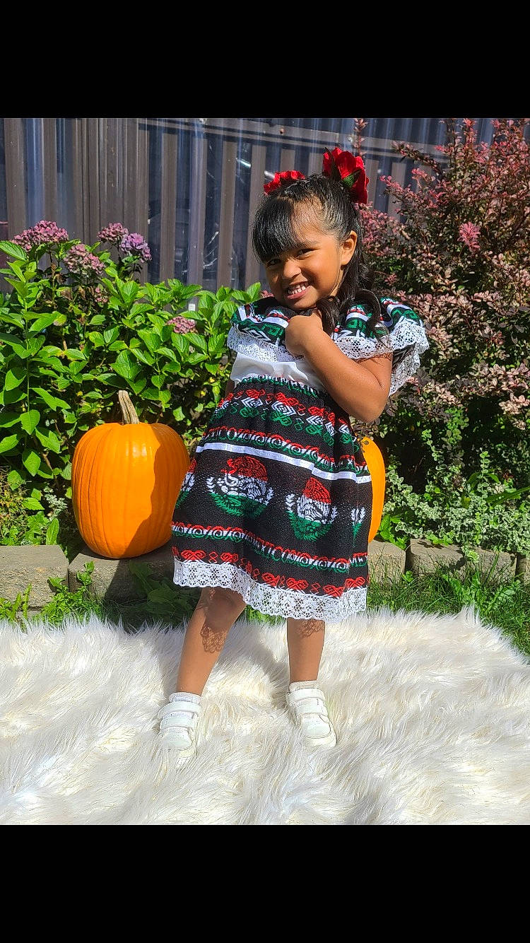 Kailani is registered to the contest to win money with this photo: baby_toddler_clothing, botany, calabaza, cucurbita, dress, flower, gourd, grass, happy, joy, leaf, leg, mammal, people_in_nature, person, plant, pumpkin, smile, squash, summer
