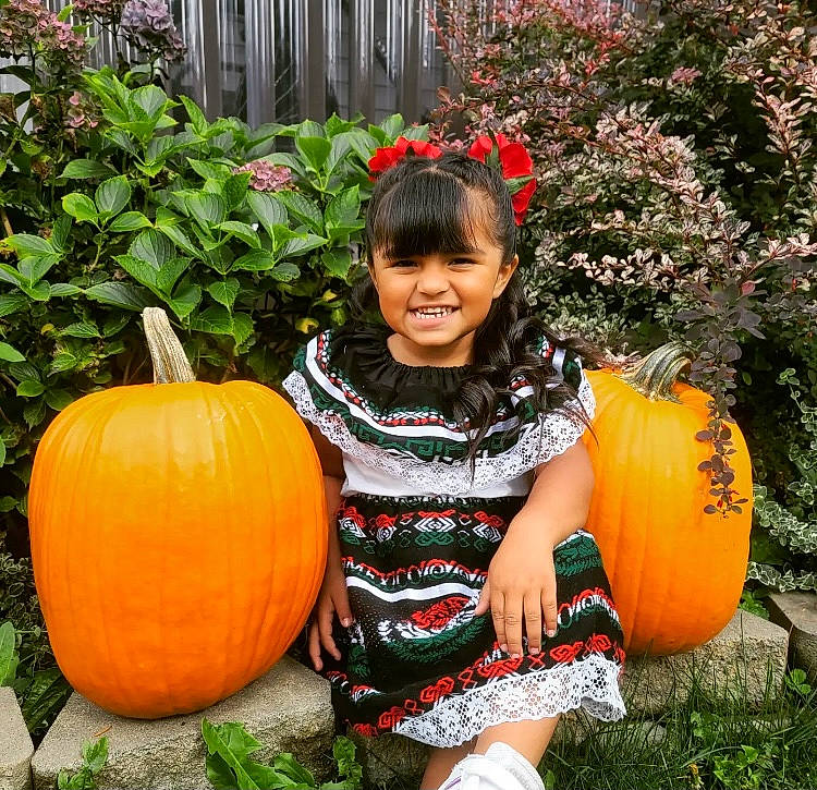 Kailani joined the competition — help win amazing prizes! botany, calabaza, clothing, cucurbita, flower, gourd, grass, happy, joy, leaf, local_food, natural_foods, orange, people_in_nature, person, plant, pumpkin, smile, squash, vegetable