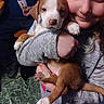 animal, casual_clothing, child, companion, cozy, cute, dog, face, floor, green_marble, holding, human, indoor, light, love, pet, puppy, smiling, sweater, young