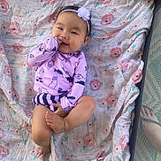Haelyn is registered to the contest to win money with this photo: baby, bed, blanket, clothing, crib, dress, face, furniture, happy, head, infantbed, laughing, newborn, pajamas, person, photography, portrait, quilt, sitting, smile