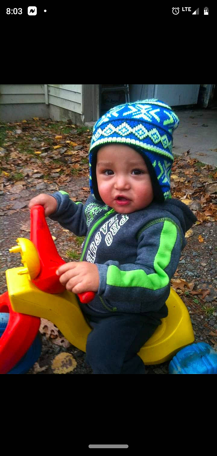 Calvin is registered to the contest to win money with this photo: baby, baby_playing_with_toys, baby_products, baby_toddler_clothing, baby_toys, bonnet, child, costume_accessory, headwear, nose, person, plastic, play, riding_toy, sitting, toddler, toy, toy_vehicle, tricycle