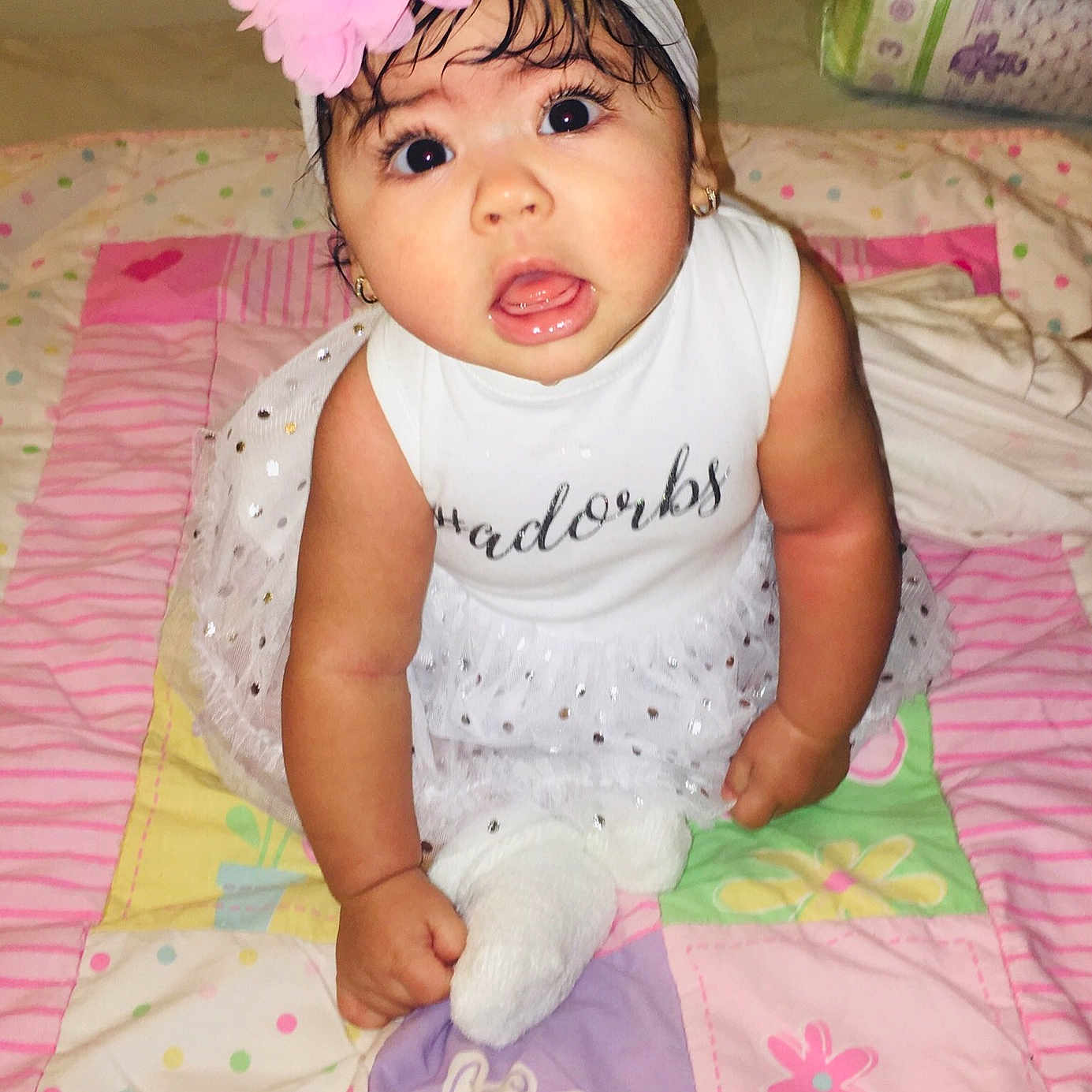 Ashley is registered to the contest to win money with this photo: baby, baby_products, baby_toddler_clothing, child, hair_accessory, headband, headgear, headwear, person, pink, product, smile, surprise, toddler