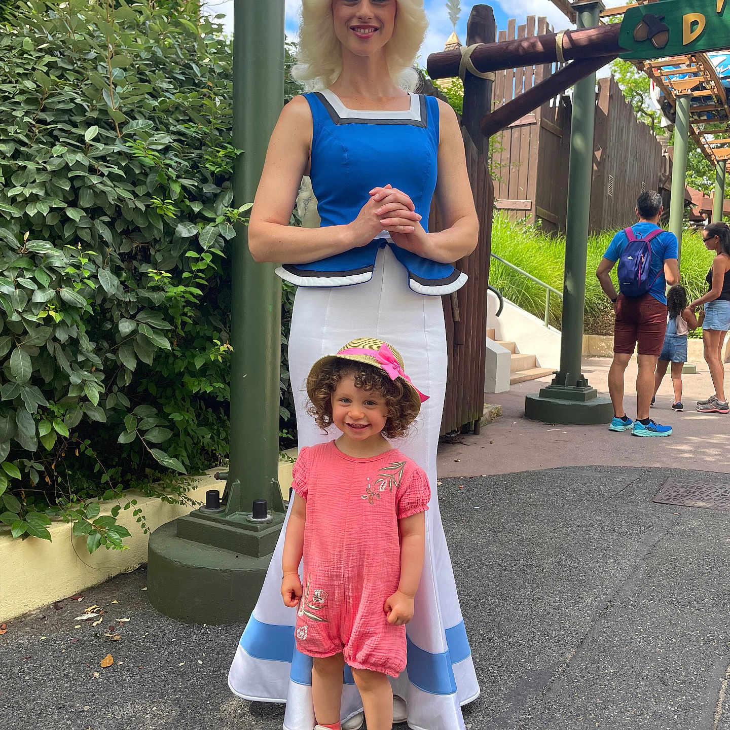 Iris a rejoint le concours — aidez-le/la à gagner de superbes lots ! amusement_park, blue_dress, casual, child, curly_hair, girl, greenery, happy, hat, outdoor, people, pink_clothing, portrait, princess_costume, romper, sidewalk, smiling, sunny, white_skirt, woman