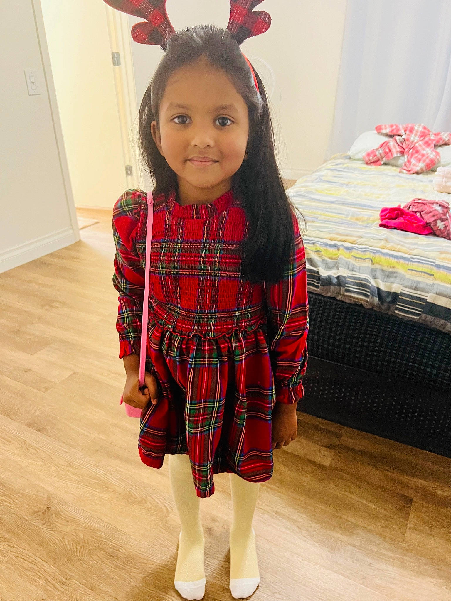 Lakeish is registered to the contest to win money with this photo: baby_toddler_clothing, clothing, dress, eye, flooring, hair, happy, head, human_body, joy, leg, person, pink, plaid, product, red, skin, sleeve, standing, tartan