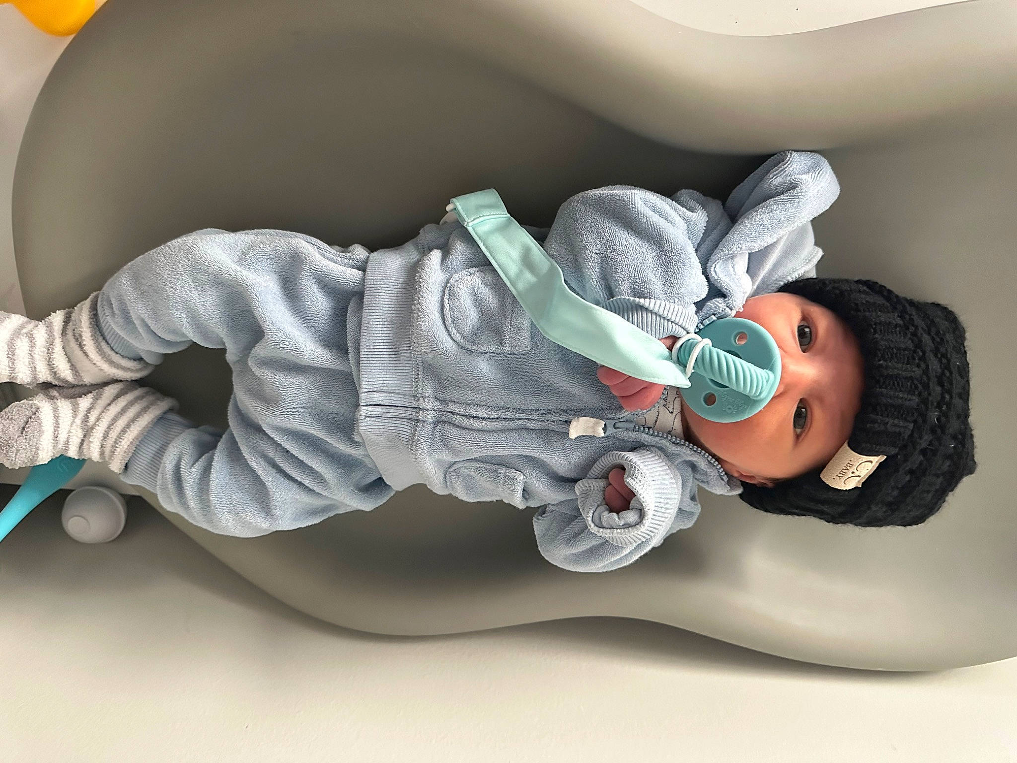 Caden is registered to the contest to win money with this photo: arm, auto_part, baby, baby_products, baby_sleeping, carmine, child, comfort, elbow, fictional_character, headwear, linens, nap, person, personal_protective_equipment, plastic, room, sitting