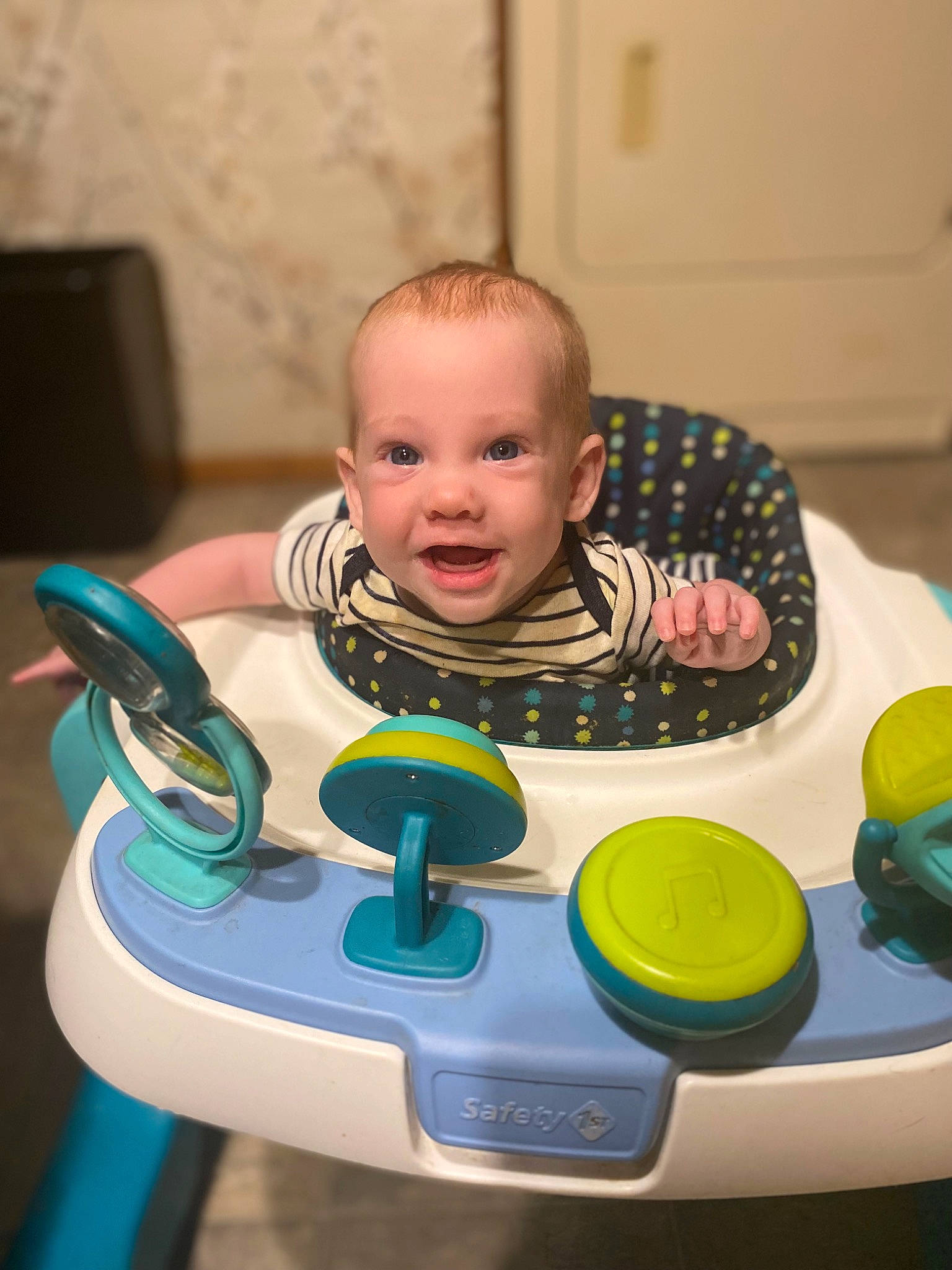 Samantha is registered to the contest to win money with this photo: baby, baby_playing_with_toys, baby_products, baby_toddler_clothing, baby_toys, cheek, child, facial_expression, fun, hairstyle, mouth, person, plastic, play, room, sitting, smile, steering_wheel, toddler, toy