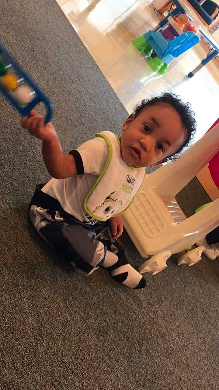 Aceton is registered to the contest to win money with this photo: baby, baby_carriage, baby_products, baby_safety, baby_toddler_clothing, comfort, flooring, fun, hardwood, human_leg, knee, leg, leisure, person, sitting, sock, thigh, tire, toddler, wheel