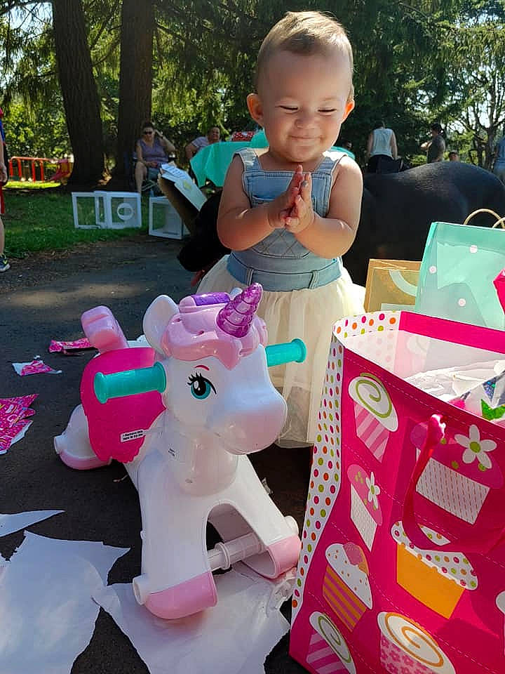 Sandra is registered to the contest to win money with this photo: baby, baby_toddler_clothing, box, child, event, fun, games, grass, happy, joy, leisure, magenta, party_supply, person, pink, public_space, recreation, stuffed_toy, toddler, toy