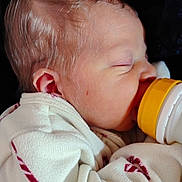 Kaden joined the competition — help win amazing prizes! baby, newborn, feeding, bottle, sleeping, blanket, clothing, infant, face, head, child, cute, peaceful, closeup, portrait, soft, warm, resting, human, toddler