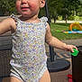 Ivy joined the competition — help win amazing prizes! toddler, child, outdoor, sunny, grass, toy, block, onesie, floral_pattern, play, patio, furniture, smiling, happy, baby, person, summer, cute, young_child, nature