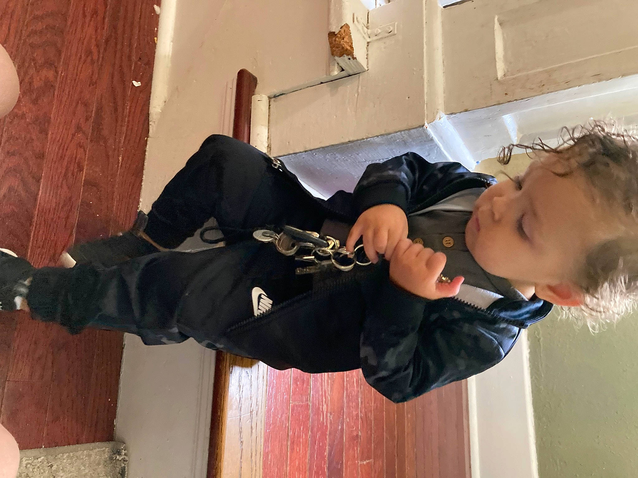 Gavonni is registered to the contest to win money with this photo: elbow, flooring, fun, gesture, happy, hardwood, human_leg, joint, knee, person, room, sitting, smile, thigh, thumb, toddler, walking_shoe, wood, wrist