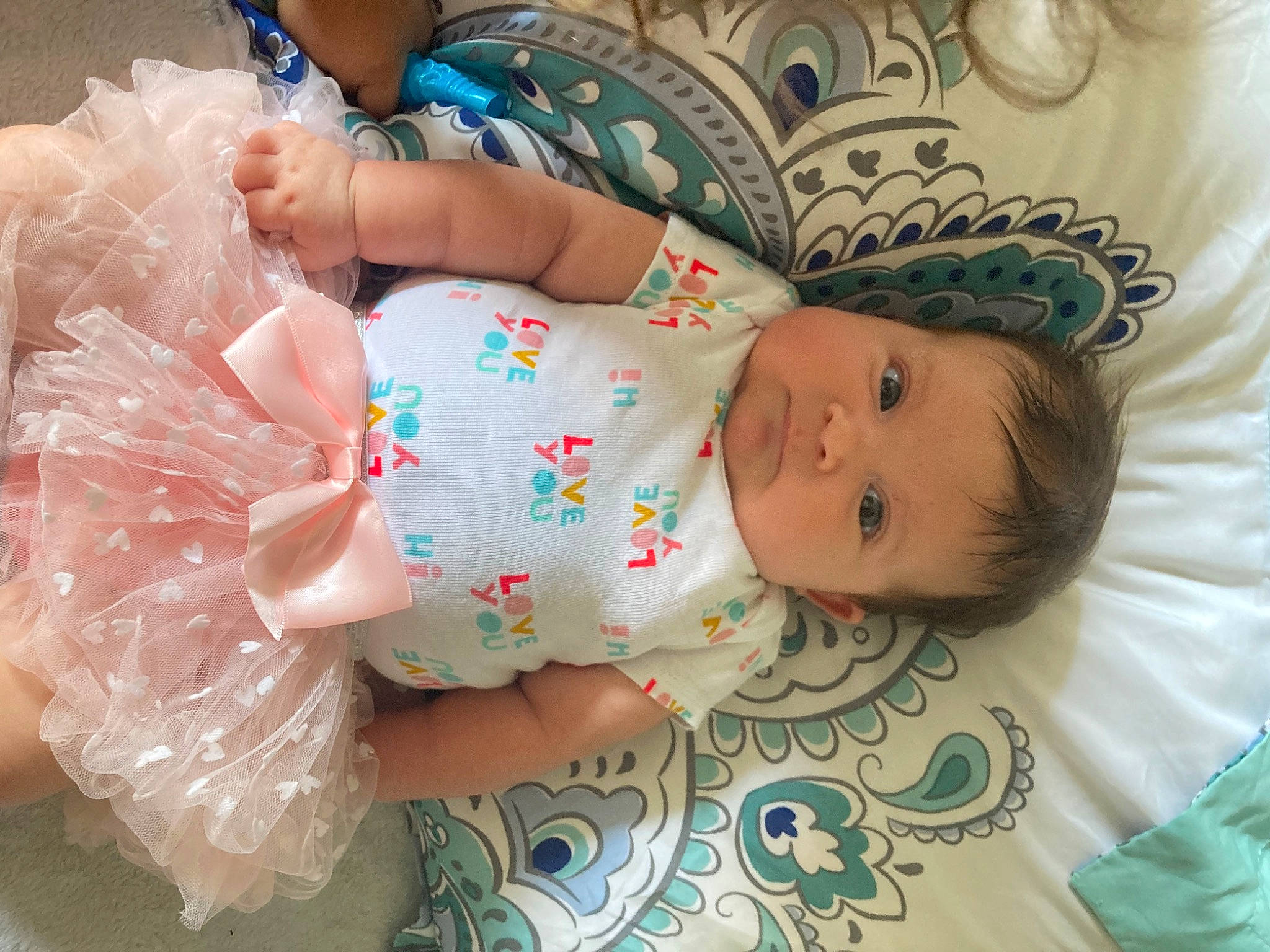 Esme is registered to the contest to win money with this photo: baby, baby_products, baby_toddler_clothing, blue, cheek, child, comfort, eye, fashion_accessory, happy, hat, head, headgear, iris, pattern, person, pink, product, skin, smile