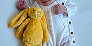 Arthur joined the competition — help win amazing prizes! baby, infant, smiling, sleeping, plush_toy, yellow_bunny, white_onesie, soft_surface, cute, peaceful, newborn, child, cozy, relaxed, baby_feet, toy, cuddly, portrait, sleepwear, small_hands
