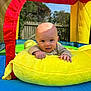 Arthur joined the competition — help win amazing prizes! baby, infant, tongue_out, plush_toy, banana, inflatable, playhouse, outdoor, child, cute, smiling, colorful, sunlight, blue_sky, fence, play, fun, young_child, toy, fabric