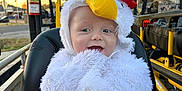 Caspian joined the competition — help win amazing prizes! baby, black_seat, chicken, child, costume, cute, fire_extinguisher, fluffy, hand, happy, headwear, outdoor, person, playful, portrait, seat, smile, sunset, vehicle, yellow