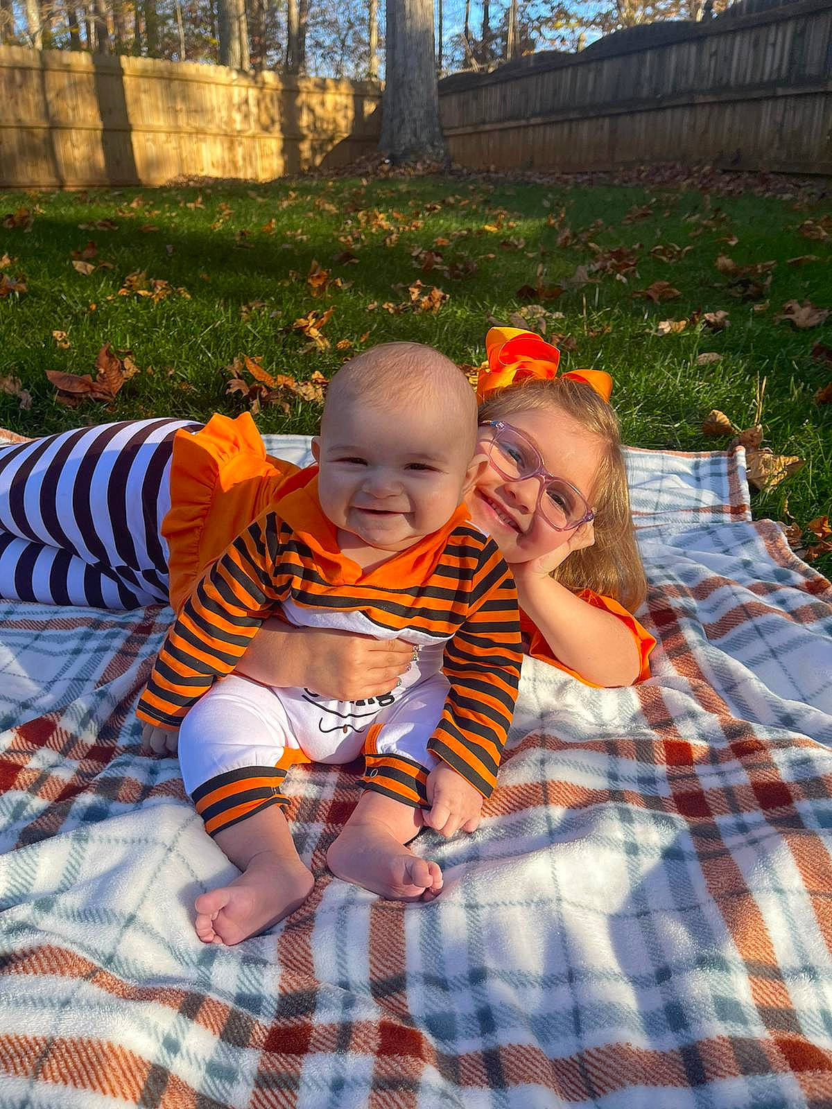 Erica joined the competition — help win amazing prizes! baby, baby_toddler_clothing, child, fun, garden, grass, happy, head, joy, leaf, leisure, linens, pattern, people_in_nature, person, plaid, plant, recreation, sitting, tartan