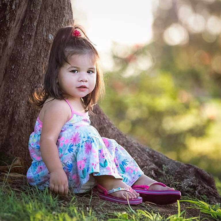Emiliana is registered to the contest to win money with this photo: beauty, child, child_model, dress, eye, grass, hair, hairstyle, lady, long_hair, people_in_nature, person, photograph, photography, pink, sitting, skin, spring, summer, toddler