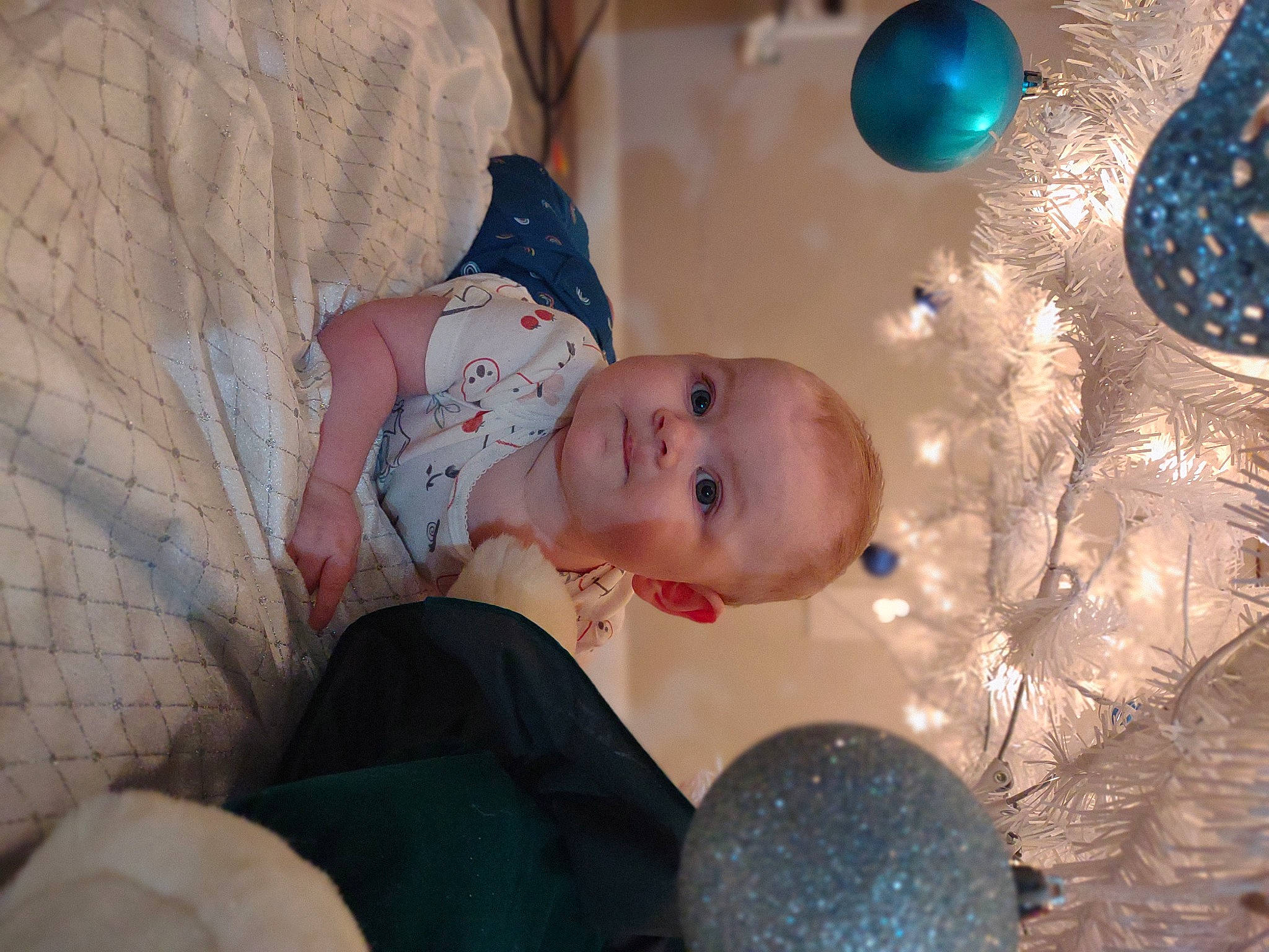 Jillian joined the competition — help win amazing prizes! baby, blue, child, christmas, christmas_decoration, christmas_ornament, event, facial_expression, fun, happy, head, holiday, holiday_ornament, leisure, ornament, pattern, person, textile, toddler, tree