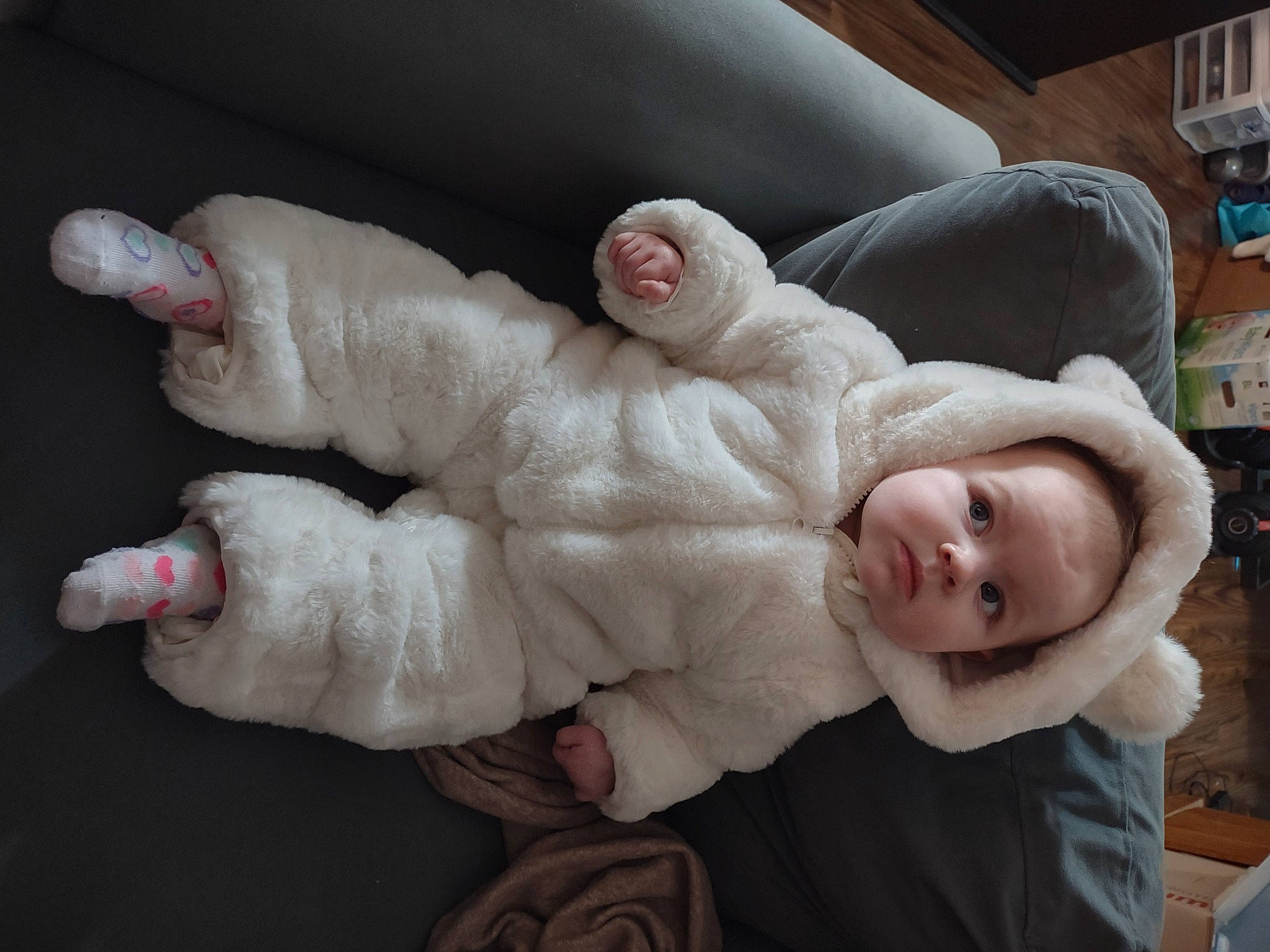 Jillian is registered to the contest to win money with this photo: baby_toddler_clothing, cheek, child, comfort, eye, felidae, flooring, foot, fur, gesture, head, human_body, human_leg, leg, person, skin, smile, thumb, toddler, wood