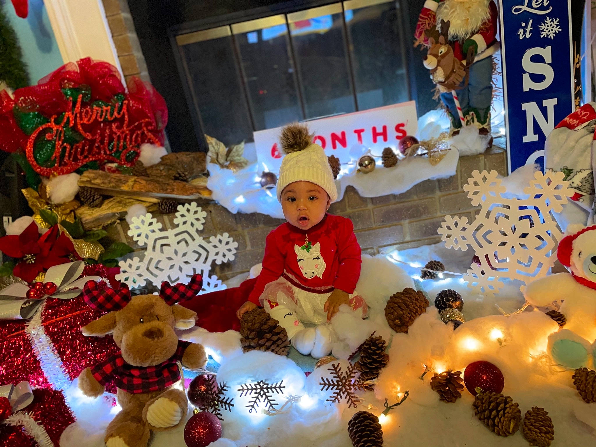 Keoni is registered to the contest to win money with this photo: baby_toddler_clothing, christmas, christmas_decoration, christmas_eve, christmas_ornament, costume_accessory, costume_hat, decoration, event, fictional_character, hat, headwear, holiday, interior_design, ornament, person, plush, stuffed_toy, surprise, teddy_bear