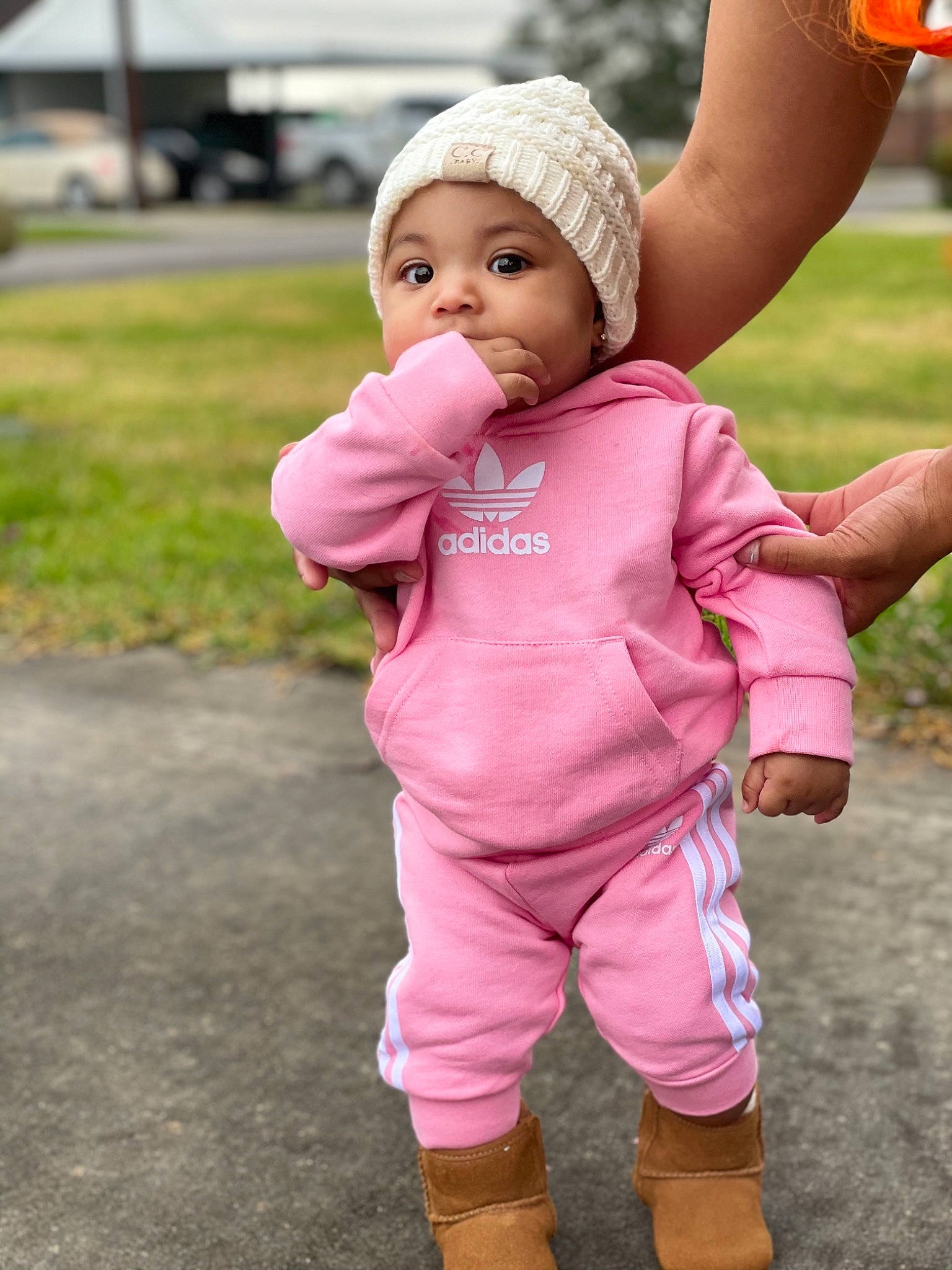 Keoni is registered to the contest to win money with this photo: baby, baby_products, baby_toddler_clothing, bonnet, boot, bracelet, cap, child, finger, headwear, overall, person, pink, sock, thumb, toddler